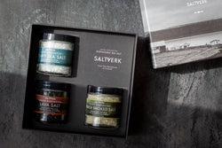 Box of Saltverk salt products on a dark surface with a blurred background